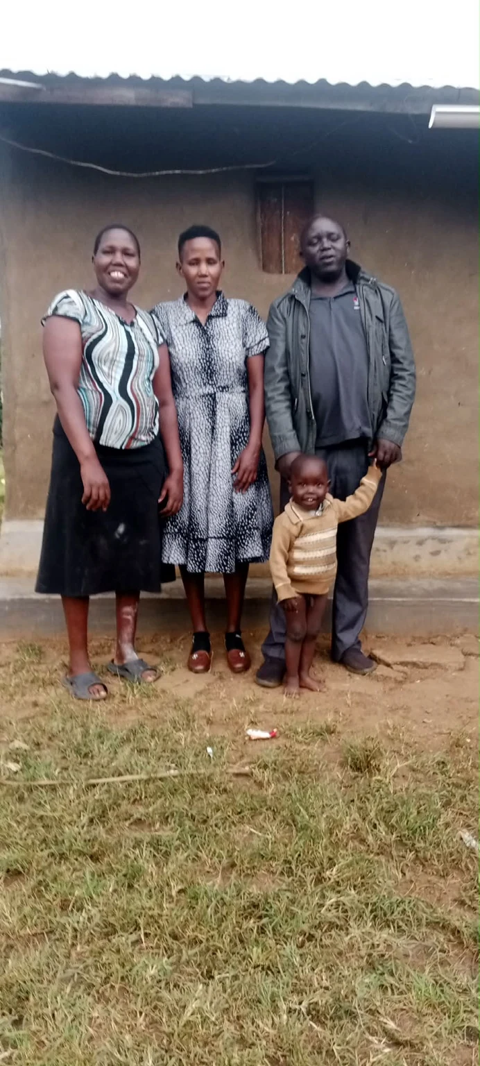 Members of a family standing together outside a home
